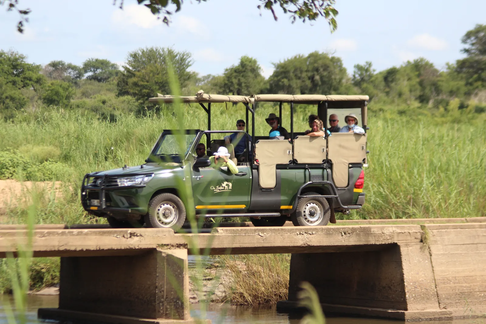 Private safari vehicle crossing a low-water bridge in Kruger National Park